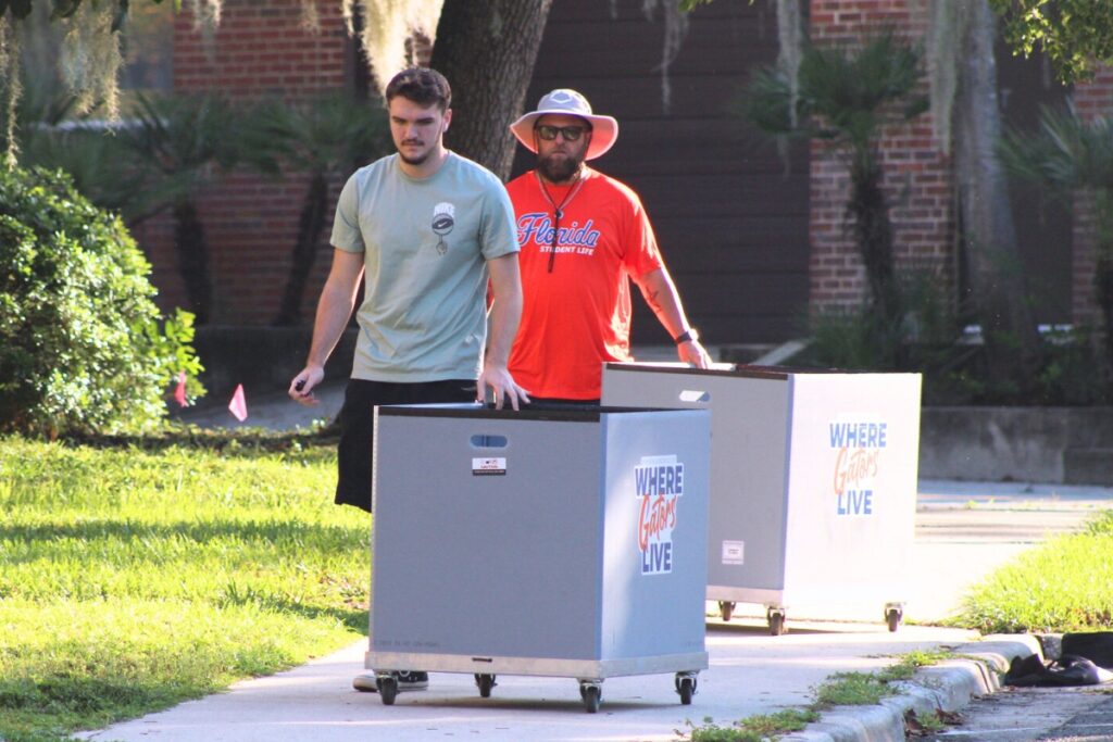 Empty carts are rolled down the sidewalk Saturday morning during UF's fall move-in. Photo by Nick Anshultz
