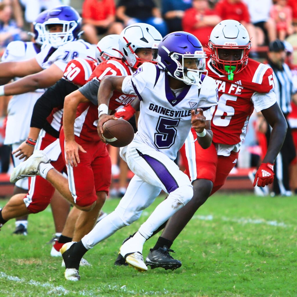 Gainesville quarterback Jai-shawn Sanford scrambles against Santa Fe on Thursday. Photo by C.J. Gish