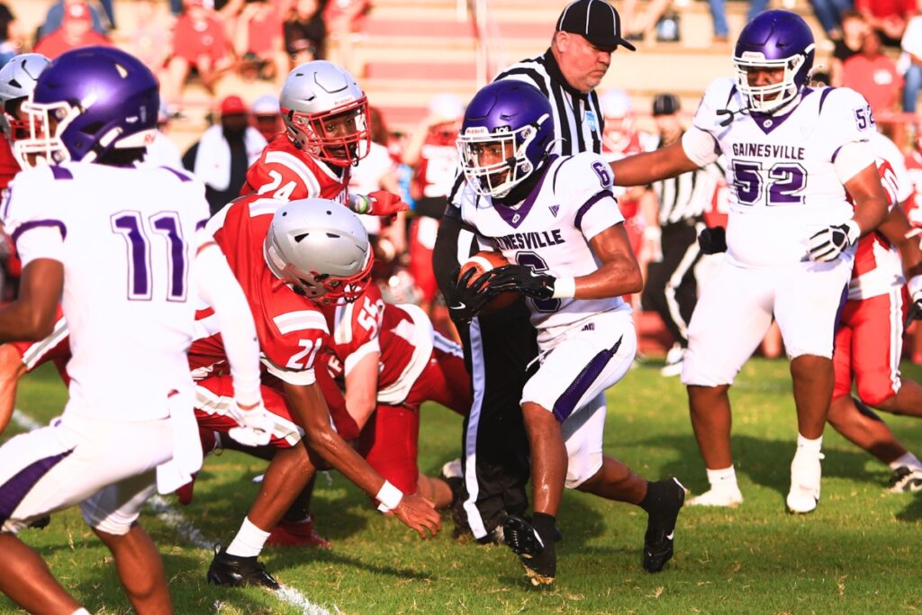 Gainesville's Jason Phillips with a run against Santa Fe on Thursday. Photo by C.J. Gish