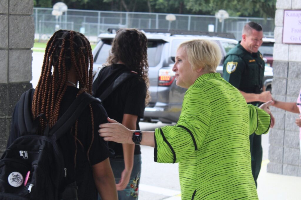 Interim Superintendent Dr Kamala Patton directs Kanapaha Middle School students to the red carpet Monday morning. Photo by NIck Anschulz