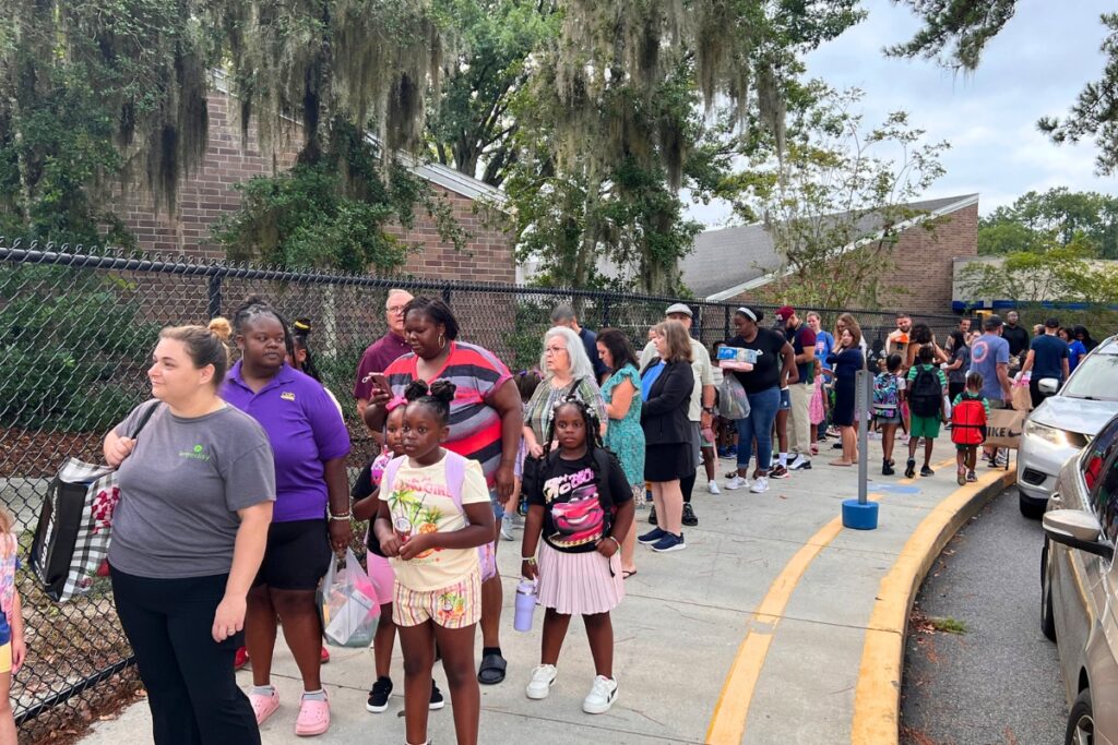 Kimbell Wiles Elementary School families wait in line to be let into classrooms on Monday morning. Photo by Nick Anshulz