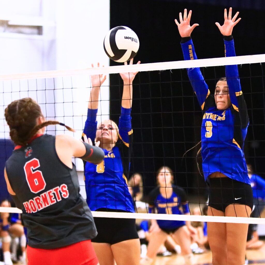 Newberry's Livi Clanton (8) and Carly Myers (9) go for a block against Lafayette on Thursday. Photo by C.J. Gish