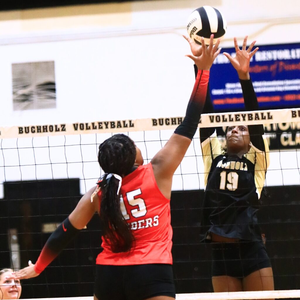 Santa Fe's Ajah Graddy (15) and Buchholz's Aaliyah Ray (19) battle at the net. Photo by C.J. Gish