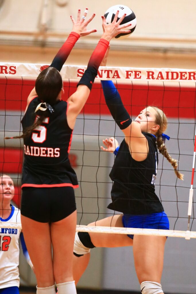 Santa Fe's Ella Schneider (5) and Branford's Anabella Dicks (8) battle at the net. Photo by C.J. Gish