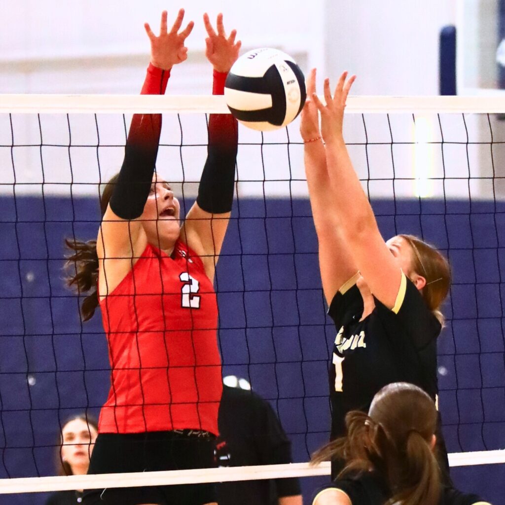 Santa Fe's Emarie Carlisle (2) blocks Buchholz's Julia Almond (7) at the net on Thursday. Photo by C.J. Gish