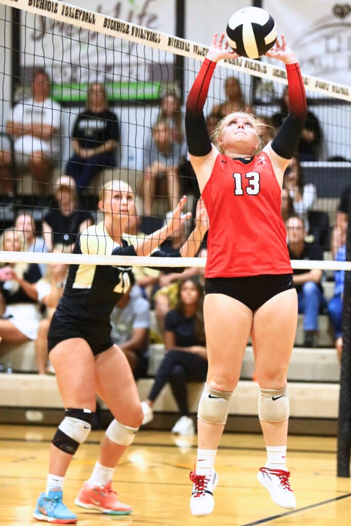 Santa Fe's Gracyn Marshall sets the ball against Buchholz. Photo by C.J. Gish