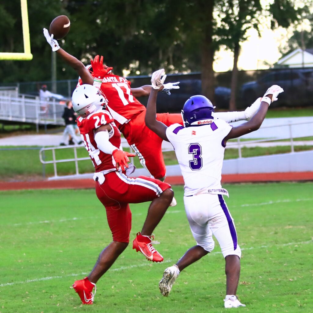 Santa Fe's Jayvin Williams attempts to intercept a pass against Gainesville on Thursday. Photo by C.J. Gish
