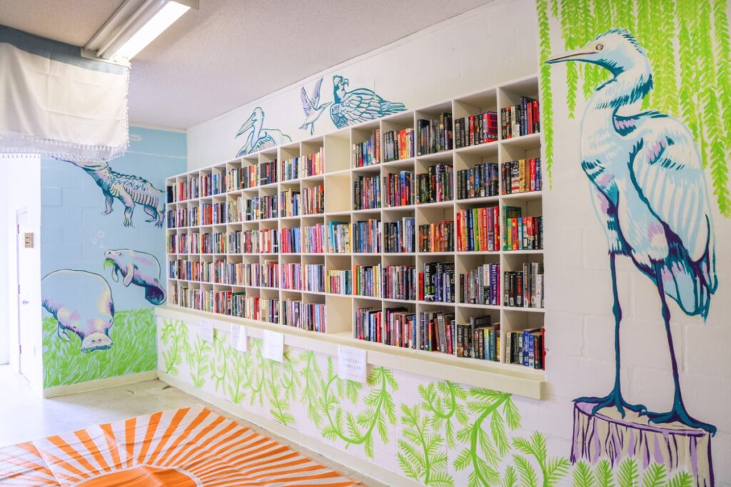 The new library space at GRACE Marketplace with a mural painted by Meghan Haile, a Lynx bookstore employee. Courtesy of The Lynx