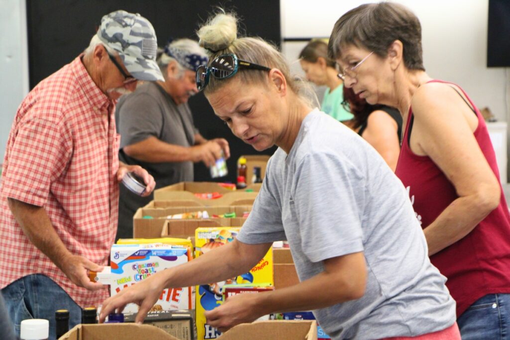 Volunteers help organize food delivery to Deeper Purpose Community Church's food pantry. Photo by Lillian Hamman (1)