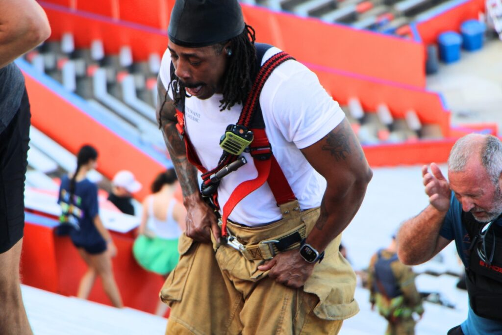 A Gainesville Fire Rescue firefighters pushes to the top of Ben Hill Griffin Stadium during the 911 remembrance stair climb. Photo by Lillian Hamman