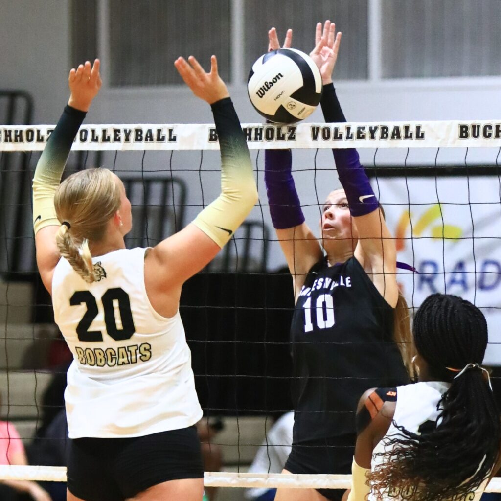 Buchholz's Aubrey Waters (20) battles at the net with Gainesville's Charlotte Judge (10). Photo by C.J. Gish 1 (1)