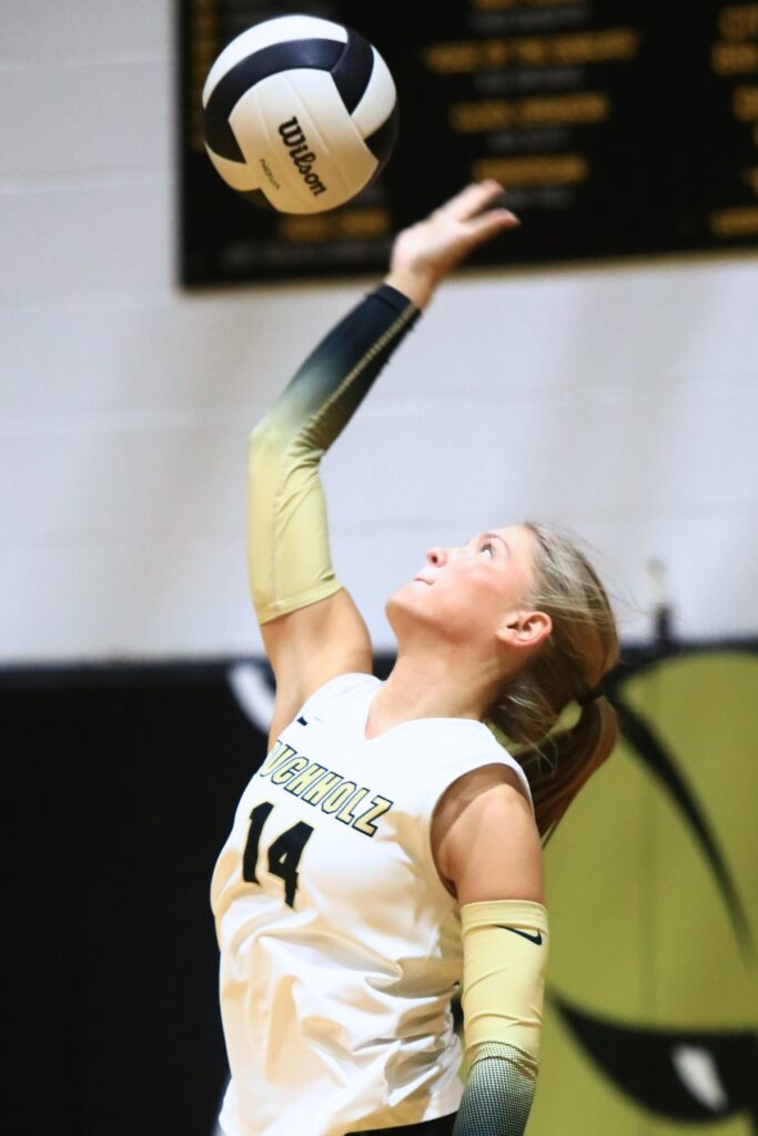 Buchholz's Avery Hayse (14) with a serve against West Port (Ocala). Photo by C.J. Gish
