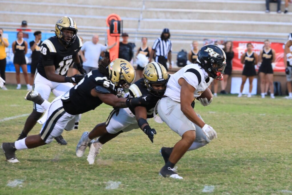Buchholz's Caleb Young Jr. (5) and Jayvyn Williams (35) bring down a Richmond Hill (GA) runner. Photo by Seth Johnson