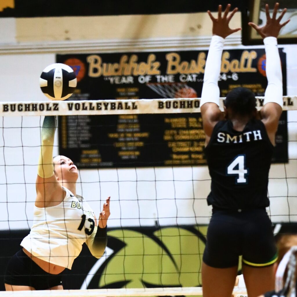 Buchholz's Delaney Deremer (13) with a hit against West Port (Ocala). Photo by C.J. Gish