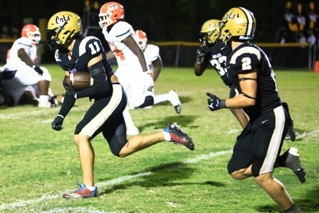 Buchholz's Evan Amar (11) returns an interception for a touchdown against Eastside. Photo by C.J. Gish