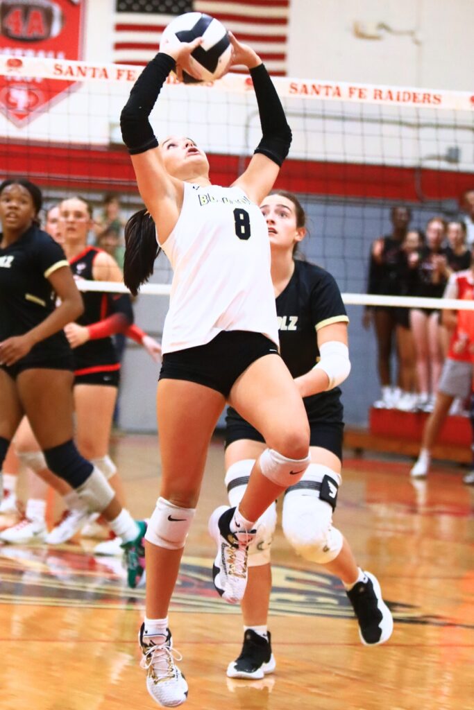 Buchholz's Izzy Carter (8) gets the ball up against Santa Fe. Photo by C.J. Gish