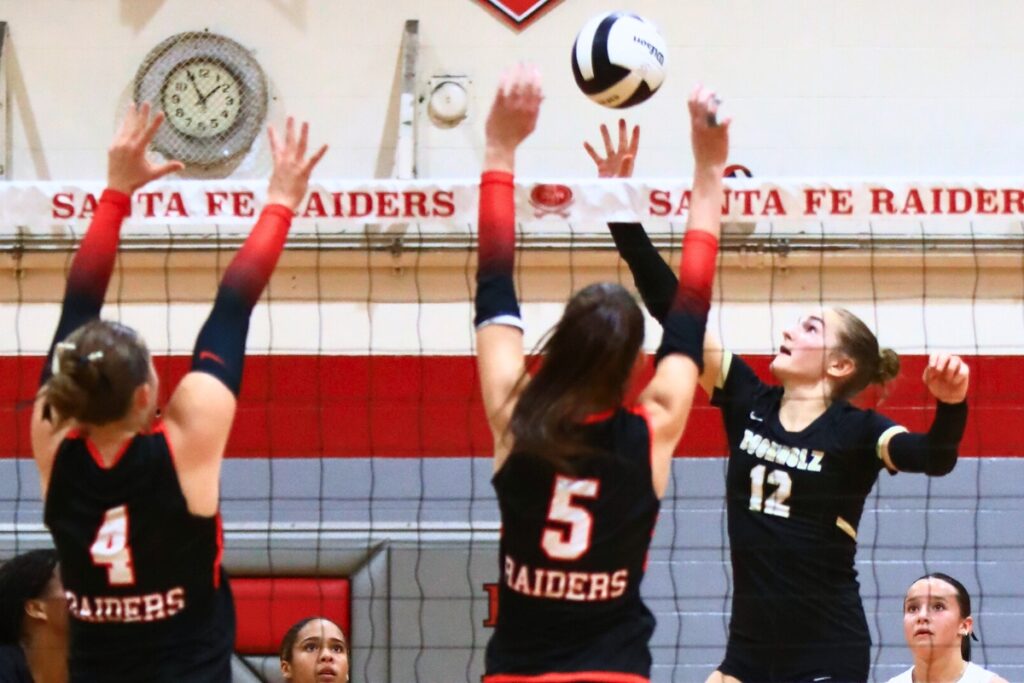 Buchholz's Taylor Sembower (12) gets the ball between Santa Fe's Brooke Findley (4) and Ella Schneider (5). Photo by C.J. Gish