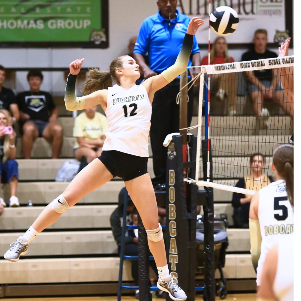 Buchholz's Taylor Sembower (12) with a hit against West Port (Ocala). Photo by C.J. Gish