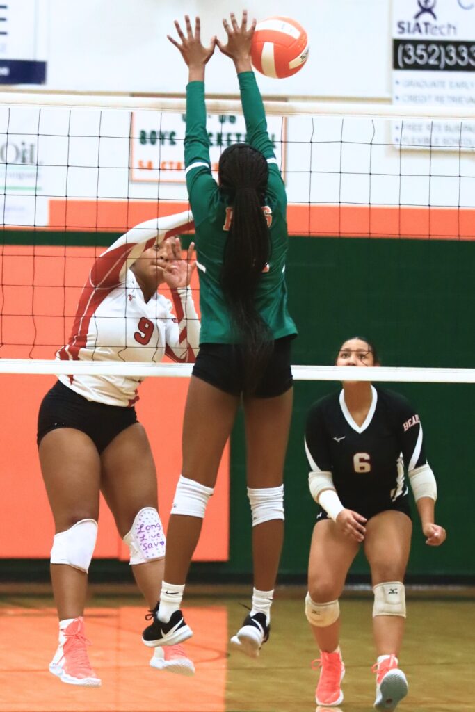 Dixie County's Kiersten Brown (9) with a hit against Eastside's Neeah Mewborn (4). Photo by C.J. Gish