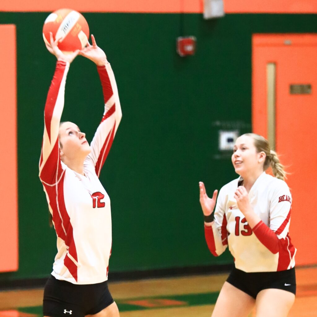 Dixie County's Macy Eplee (12) with a set against Eastside. Photo by C.J. Gish 1 (1)