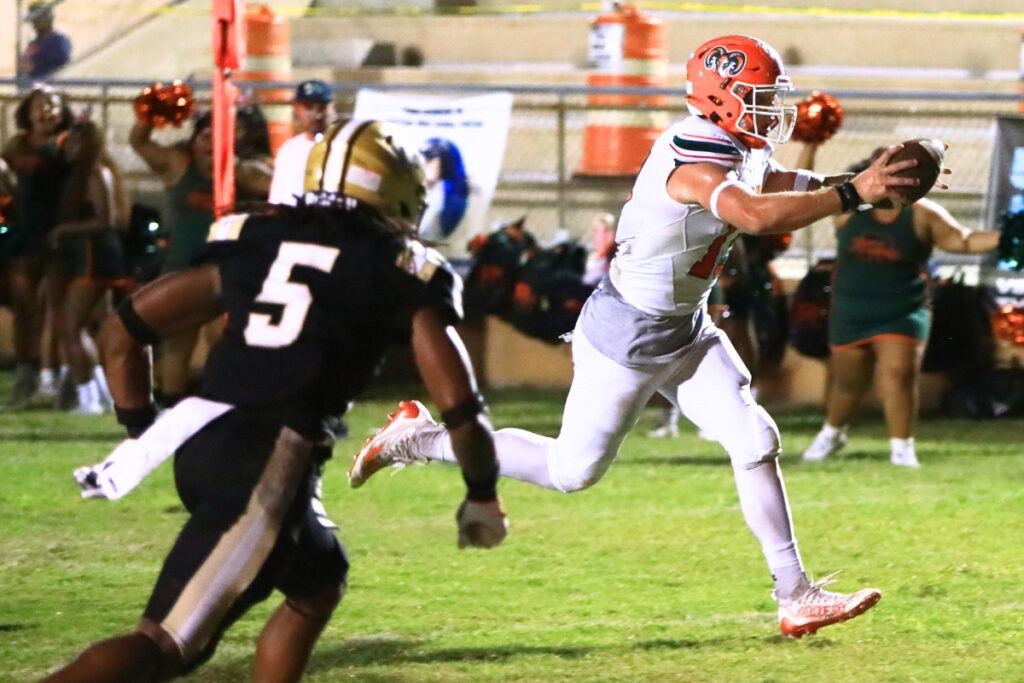 Eastside quarterback Nelson Tambling scores a first-quarter touchdown against Buchholz. Photo by C.J. Gish