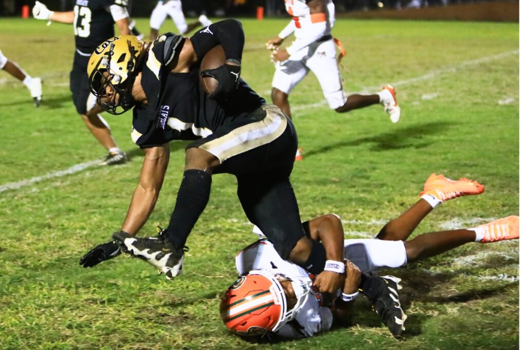 Eastside's Jayvon Comer (7) tackles Buchholz's Chris Johnson (1). Photo by C.J. Gish 1