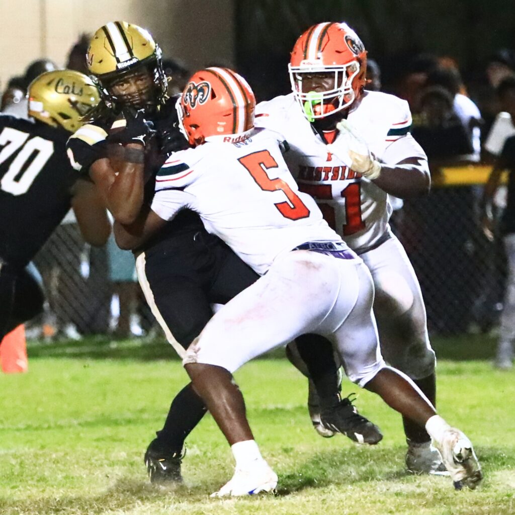 Eastside's Kamariyon Mack (5) tackles Buchholz's Chris Johnson (1) on a short pass play. Photo by C.J. Gish