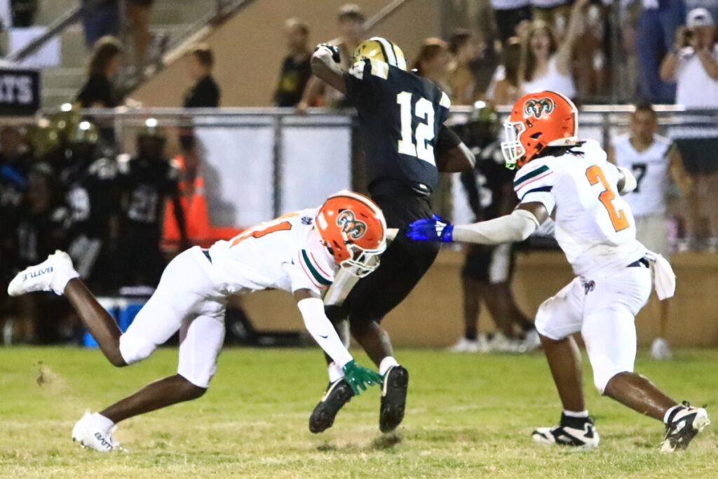 Eastside's Malicah Williams (11) and Demarco Daniels (2) tackle Buchholz's Marquel Brooks (12). Photo by C.J. Gish