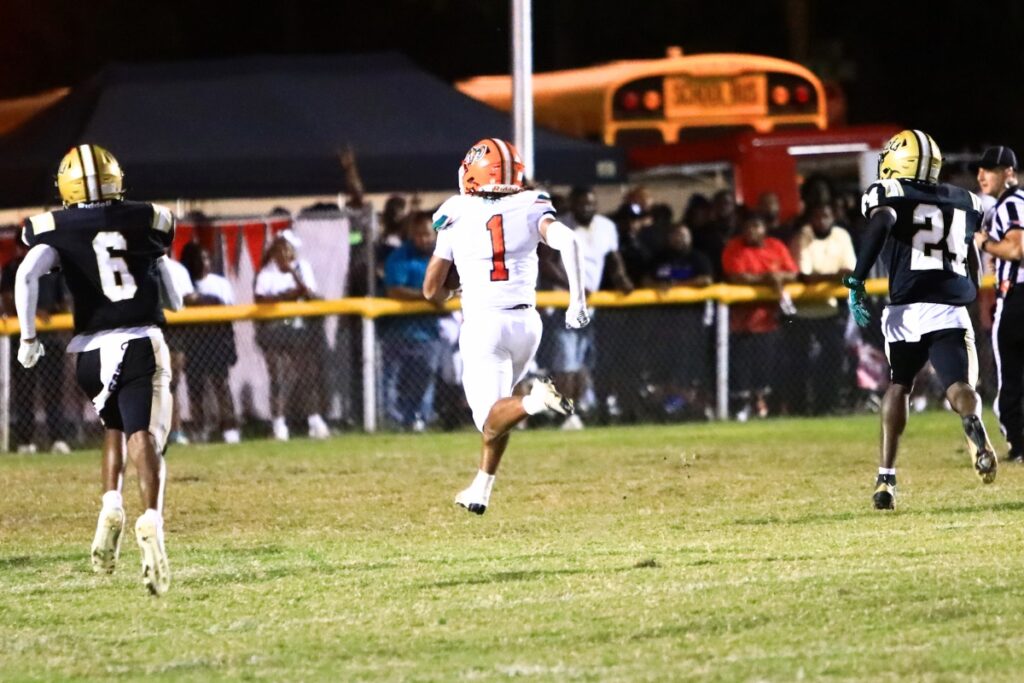 Eastside's Marcus Coefield (1) outraces Buchholz defenders for a second-quarter touchdown. Photo by C.J. Gish 1