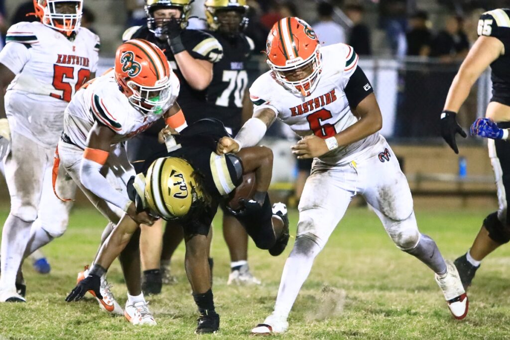 Eastside's Tramayne Montague (4) and Galen Miller (6) bring down Buchholz's Chris Johnson (1). Photo by C.J. Gish 1