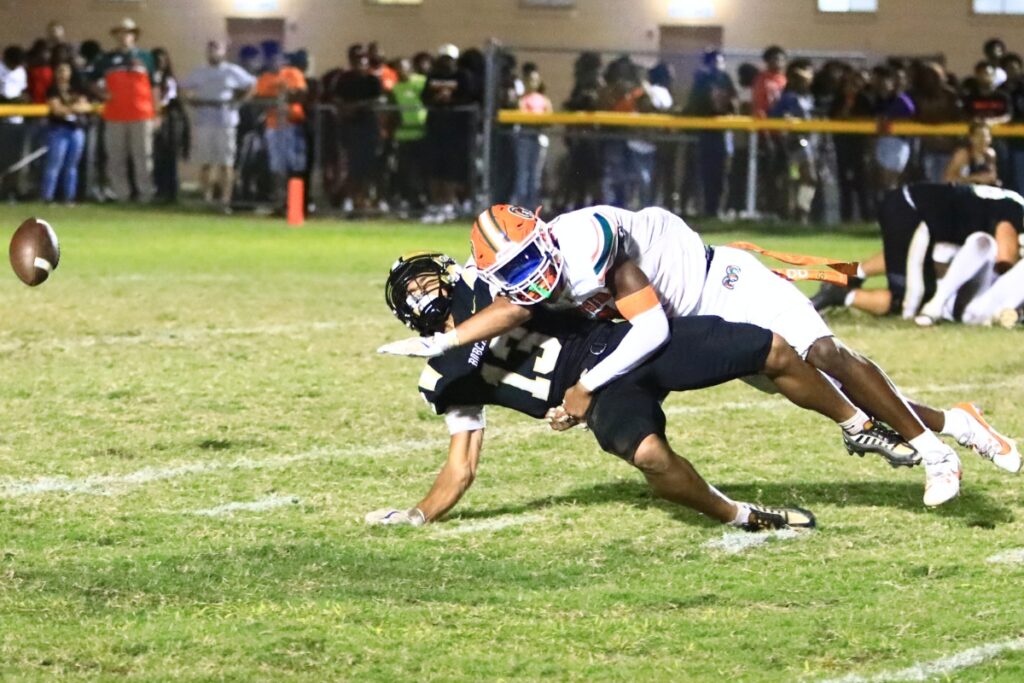 Eastside's Tramayne Montague (4) breaks up a pass intended for Buchholz's Justin Williams (13). Photo by C.J. Gish
