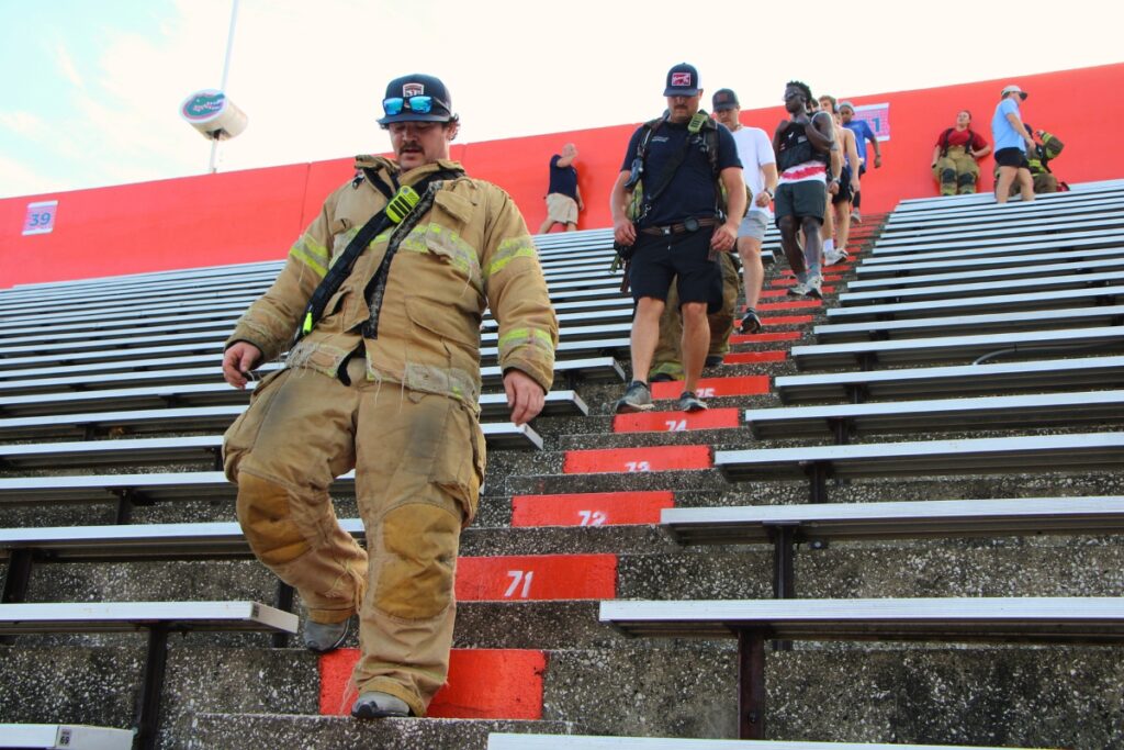 Firefighters and community members descend the stairs at Ben Hill Griffin Stadium on 911. Photo by Lillian Hamman