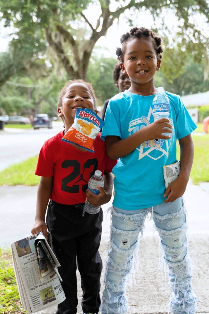 (From left) Zydarius Thomas and Derrick Singleton deliver Mainstreet Daily News print editions. Photo by Tim Rodriquez
