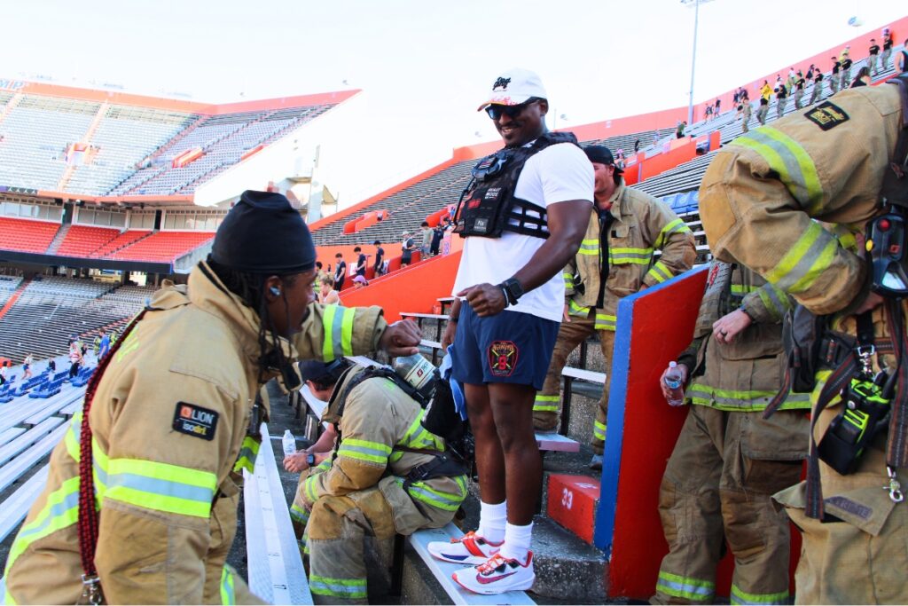 Gainesville Fire Rescue crews encourage each other with a fist bump during the annual 911 remembrance stair climb at Ben Hill Griffin Stadium.
