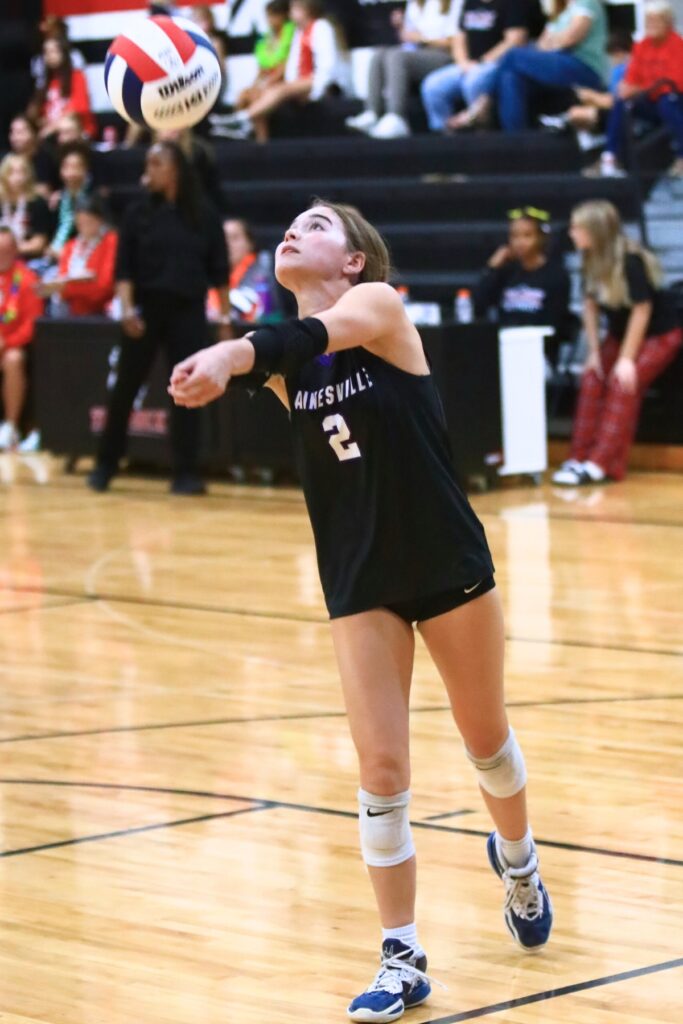 Gainesville's Addyson Hauptman (2) with a dig against The Rock. Photo by C.J. Gish