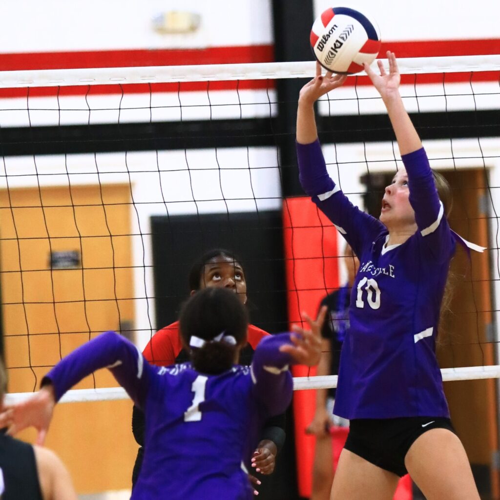 Gainesville's Charlotte Judge (10) with a set against The Rock. Photo by C.J. Gish
