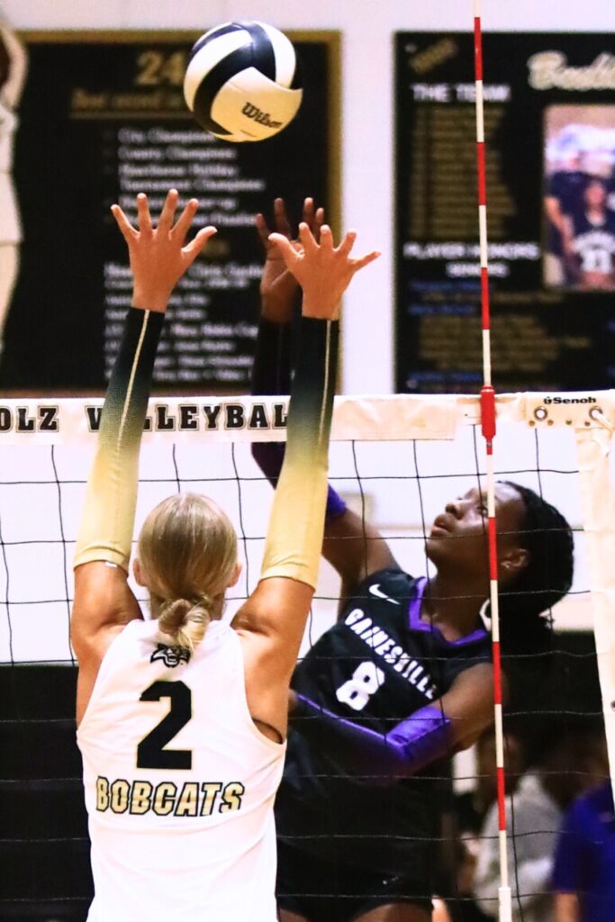Gainesville's Jorryn Dye (8) with a hit against Buchholz's Addie Sixbey (2). Photo by C.J. Gish