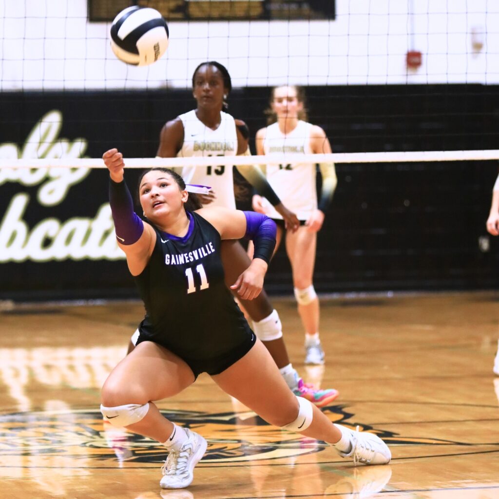 Gainesville's Kenzie Carter-Mitchell (11) dives after the ball against Buchholz. Photo by C.J. Gish