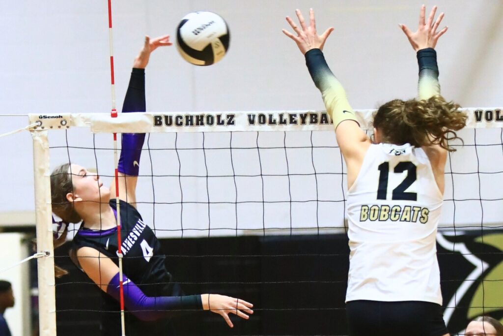 Gainesville's Rowan Kage (4) with a hit against Buchholz's Taylor Sembower (12). Photo by C.J. Gish