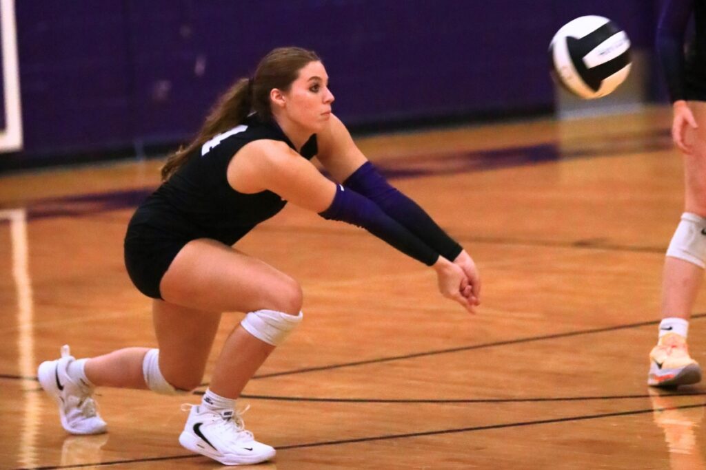 Gainesville's Whitney Kinsell (14) with a dig against Forest (Ocala). Photo by C.J. Gish