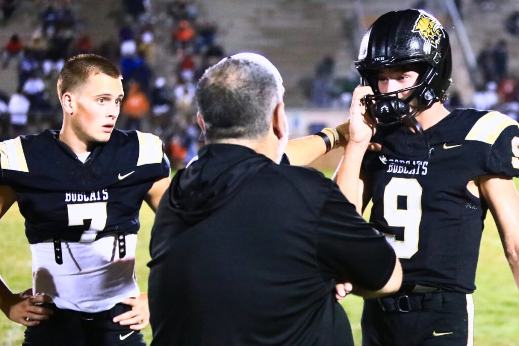 Instead of catching passes from new Buchholz quarterback Andrew Whittemore (9), wide receiver Keil McGriff (7) has spent his senior season on the sideline. Photo by C.J. Gish