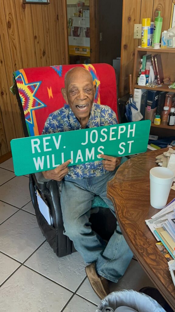 Joseph Williams holds his street sign, given my the city of Hawthorne. Courtesy Jacquelyn Randall