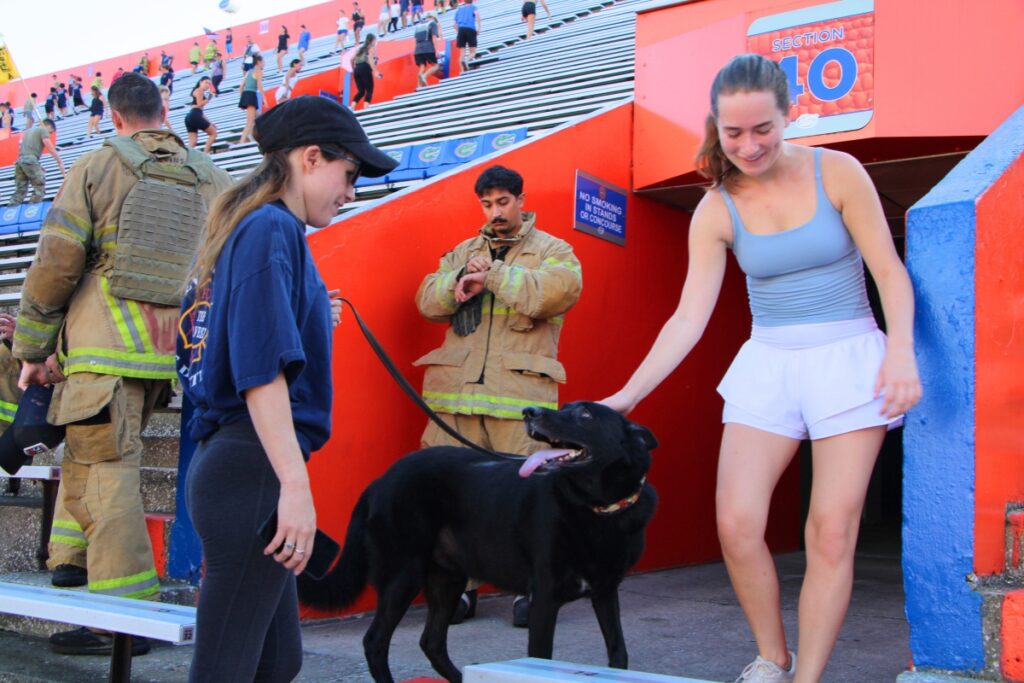 Maloy Williamson and her German Shephard, Sirius, encourage climbers honoring 911 victims. Photo by Lillian Hamman