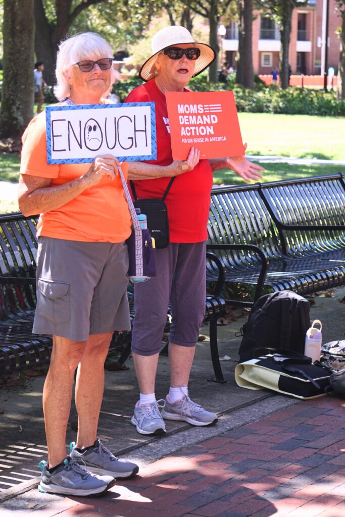 Members of the University of Florida Students Demand Action and Alachua County’s Moms Demand Action hold homemade signs before the Walkout for Safer Schools. Photo by Kirsten Rabin (1)