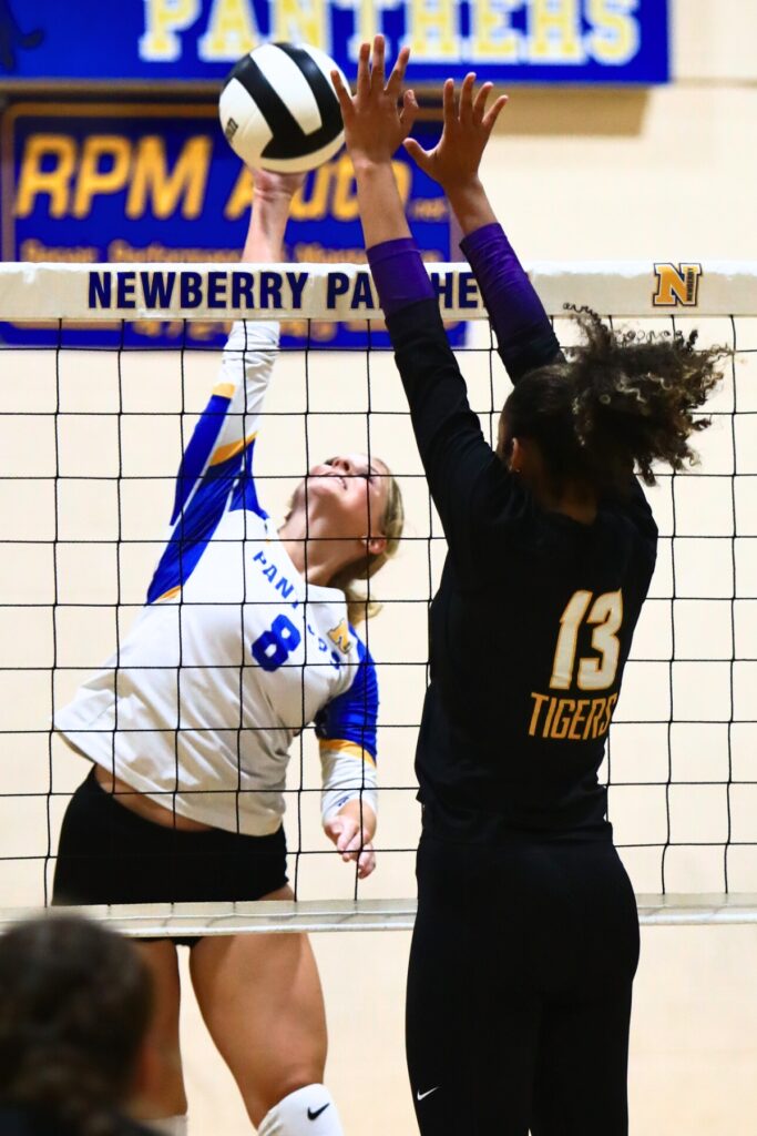 Newberry's Livi Clanton (8) with a hit against Union County's Jailyn Simmons (13). Photo by C.J. Gish