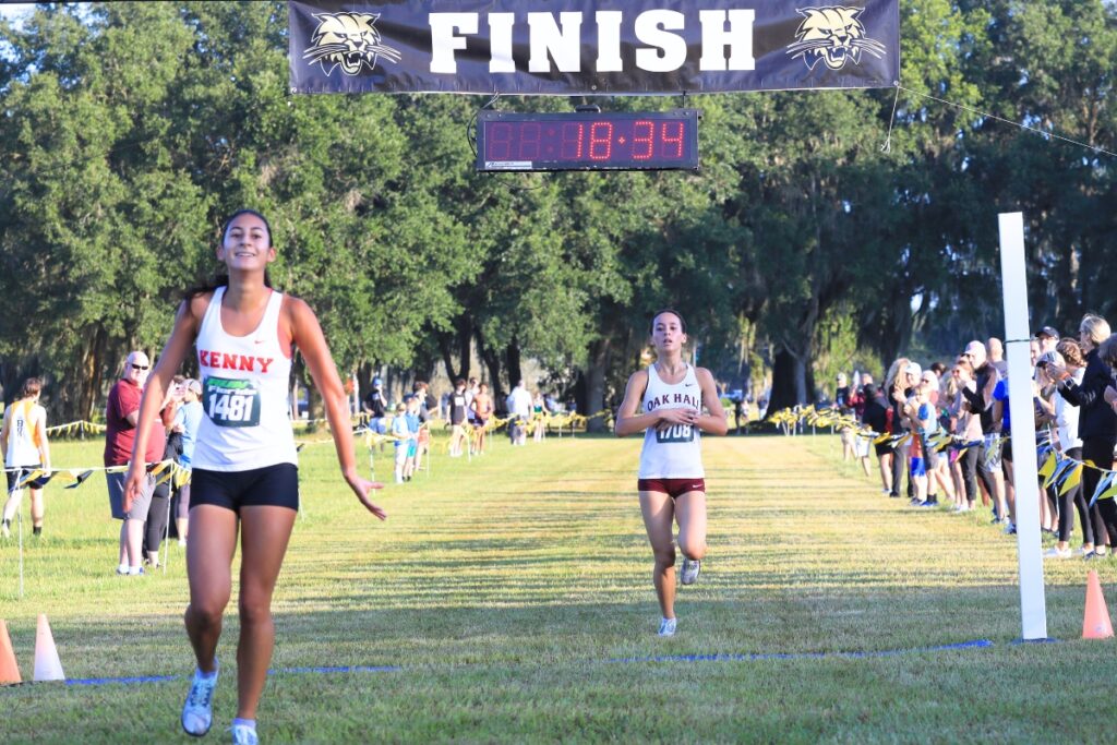 Oak Hall's Estella Collante crosses the line in second, finishing two seconds behind Bishop Kenny's Alexis Wilson. Photo by Seth Johnson