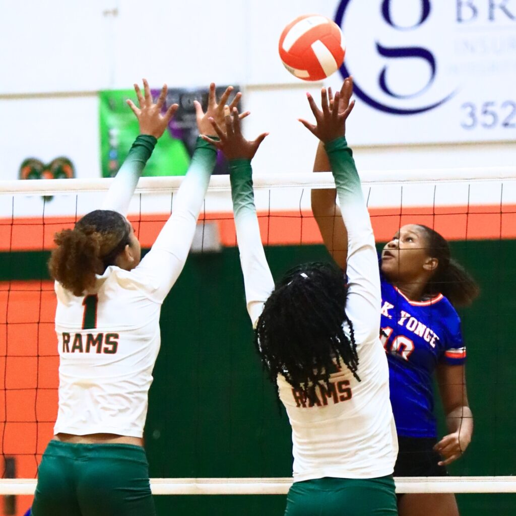 P.K. Yonge's Jada Adderly (10) with a hit against Kaylee Ovia (1) and Anijah Goss (12). Photo by C.J. Gish