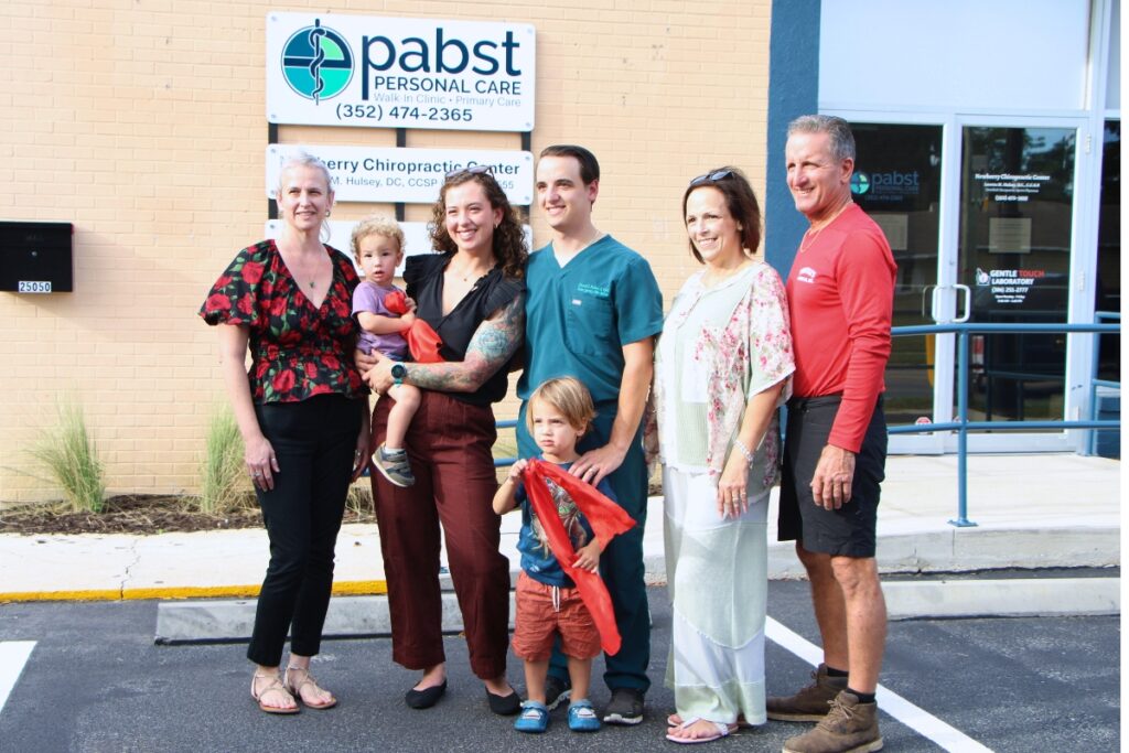 Pabst Personal Care owner and physician assistant, David Pabst (center) celebrates new clinic's open with family. Photo by Lillian Hamman