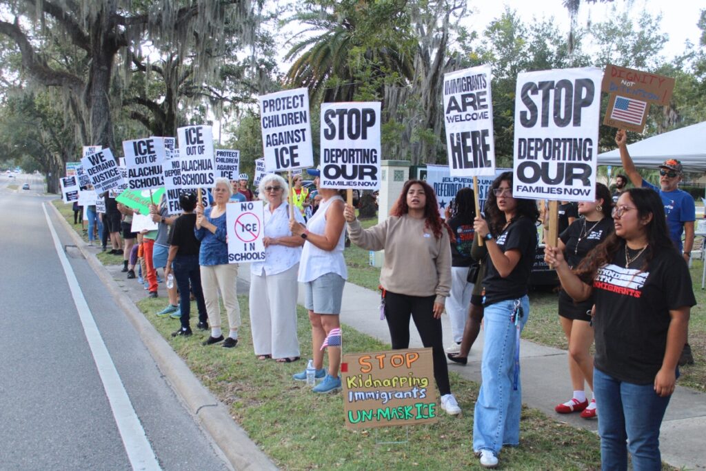 Protesters line University Avenue on Tuesday for a rally at the Alachua County School District Office. Photo by Nick Anschultz