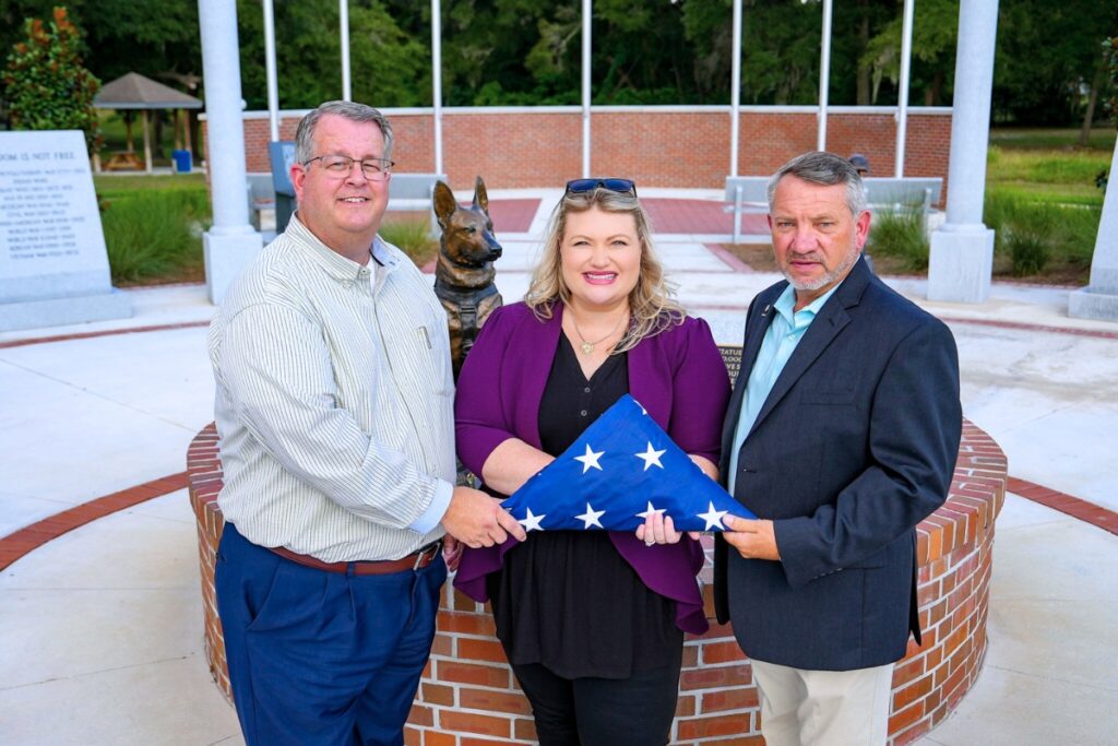 Rep. Kat Cammack presents Newberry Commissioner Mark Clark (right) and Mayor Tim Marden (left) new Veterans Memorial flags. Courtesy of Kat Cammack